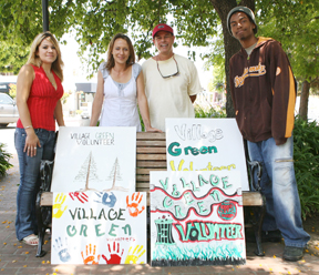 (Left to right) Senior Marla Reyes, art teacher Lorene Sosa, Temescal High School Principal Allan Tamshen and senior Taylor Ash at the Village Green displaying the new signs that volunteers will use during monthly work parties.